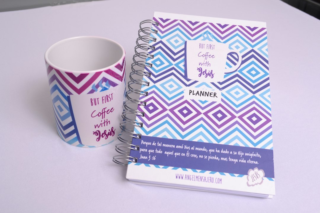 a cup of coffee next to a planner